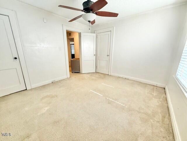 1112 N Driver St, Durham, NC 27701 - unfurnished bedroom with ornamental molding, carpet flooring, baseboards, and a ceiling fan