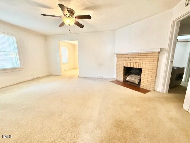 1112 N Driver St, Durham, NC 27701 - unfurnished living room featuring a brick fireplace, ceiling fan, and carpet flooring