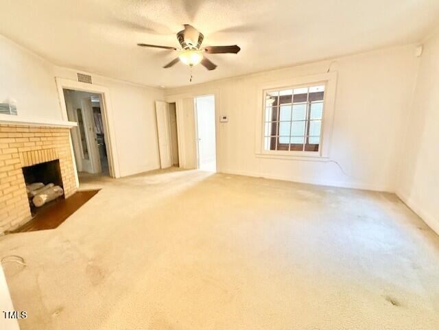 1112 N Driver St, Durham, NC 27701 - unfurnished living room with a ceiling fan, carpet floors, and a brick fireplace