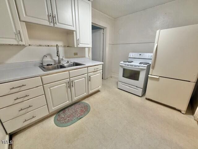 1112 N Driver St, Durham, NC 27701 - kitchen featuring white appliances, a sink, light countertops, and white cabinets