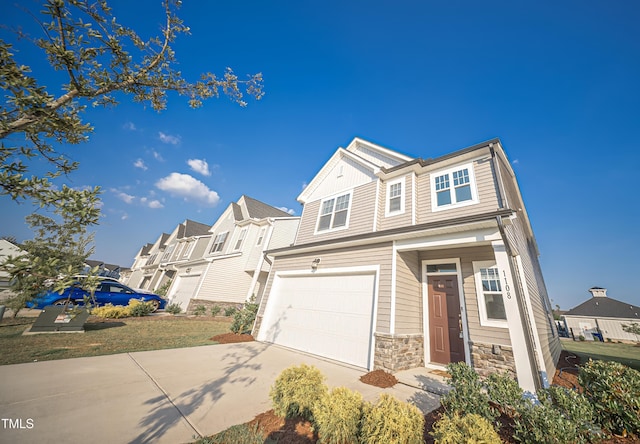 1108 Matterhorn Dr, Fuquay Varina, NC 27526 - view of front facade featuring stone siding, concrete driveway, an attached garage, a residential view, and board and batten siding