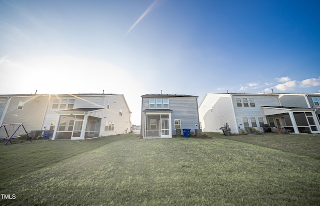 1108 Matterhorn Dr, Fuquay Varina, NC 27526 - back of house featuring a sunroom and a lawn