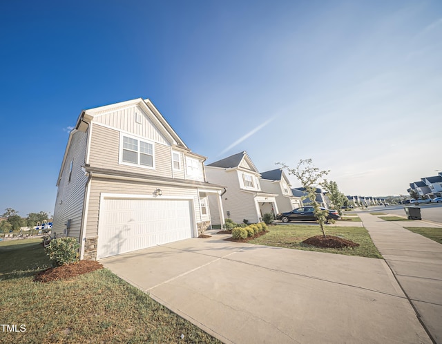 1108 Matterhorn Dr, Fuquay Varina, NC 27526 - view of front of home featuring stone siding, board and batten siding, an attached garage, and concrete driveway