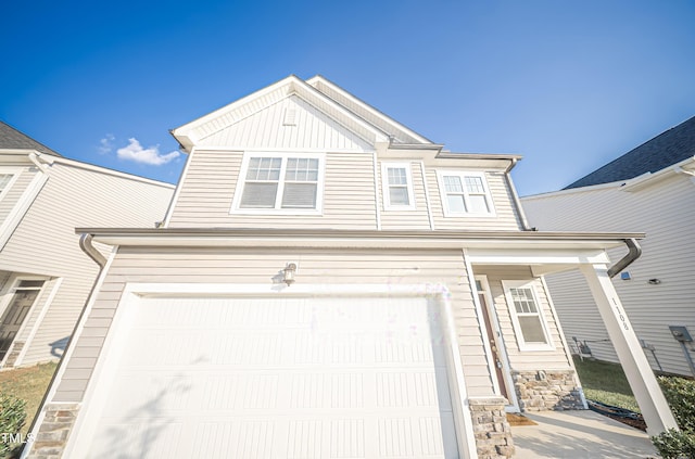 1108 Matterhorn Dr, Fuquay Varina, NC 27526 - view of front of house featuring a garage, stone siding, board and batten siding, and covered porch