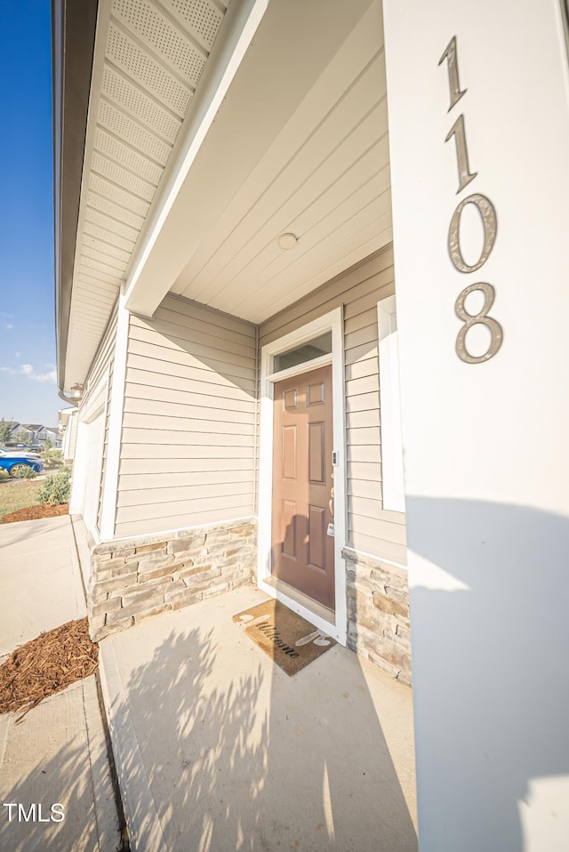 1108 Matterhorn Dr, Fuquay Varina, NC 27526 - property entrance featuring stone siding and a porch