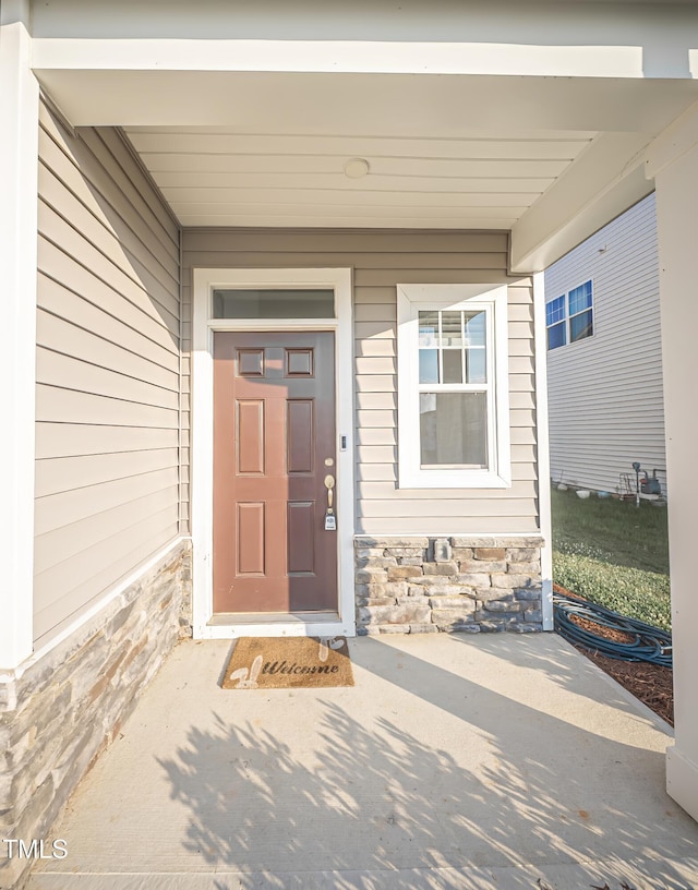 1108 Matterhorn Dr, Fuquay Varina, NC 27526 - doorway to property with stone siding and a porch