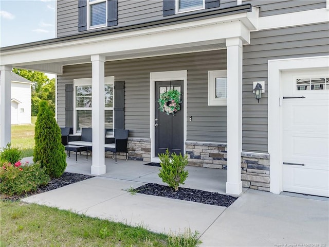 298 Turkey Trot Ln, Raeford, NC 28376 - property entrance featuring a porch, a garage, and stone siding