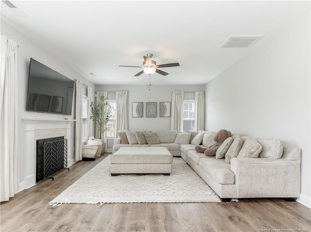 298 Turkey Trot Ln, Raeford, NC 28376 - living area featuring a ceiling fan, wood finished floors, a fireplace, and baseboards