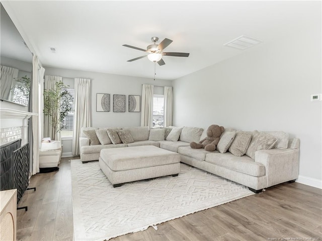 298 Turkey Trot Ln, Raeford, NC 28376 - living area with a ceiling fan, wood finished floors, a fireplace, and baseboards