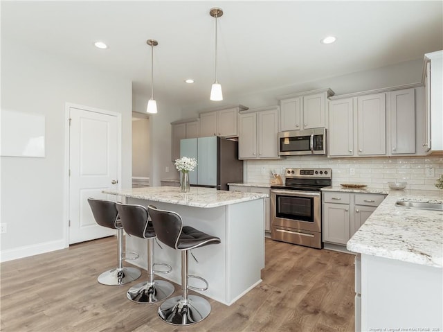 298 Turkey Trot Ln, Raeford, NC 28376 - kitchen featuring stainless steel appliances, a center island, light wood finished floors, backsplash, and recessed lighting