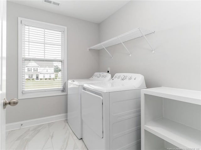 298 Turkey Trot Ln, Raeford, NC 28376 - washroom with washing machine and clothes dryer, healthy amount of natural light, light marble finish flooring, and baseboards