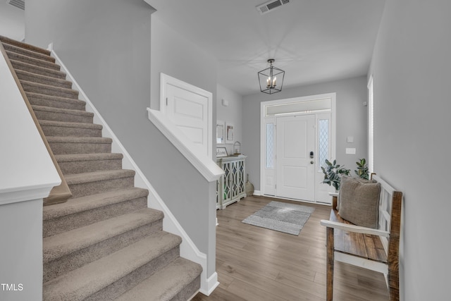 325 Buckhorn Branch Park, Clayton, NC 27520 - foyer entrance featuring stairway, wood finished floors, a chandelier, and baseboards