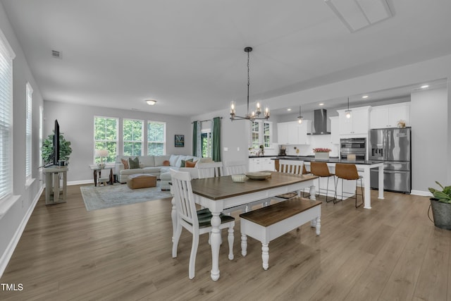 325 Buckhorn Branch Park, Clayton, NC 27520 - dining area featuring light wood-style flooring, baseboards, recessed lighting, and a chandelier
