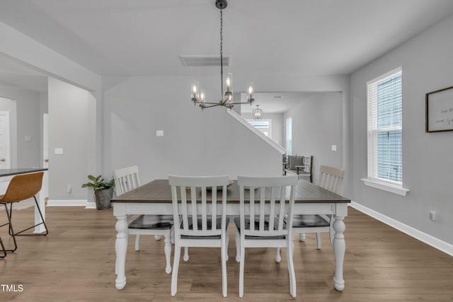 325 Buckhorn Branch Park, Clayton, NC 27520 - dining room with light wood finished floors, baseboards, and a chandelier