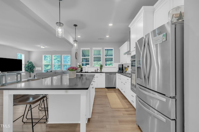 325 Buckhorn Branch Park, Clayton, NC 27520 - kitchen with stainless steel appliances, dark countertops, healthy amount of natural light, white cabinetry, and recessed lighting