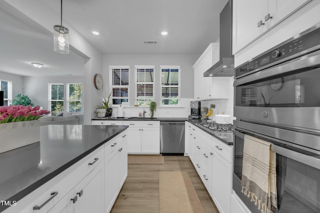 325 Buckhorn Branch Park, Clayton, NC 27520 - kitchen with appliances with stainless steel finishes, dark countertops, light wood-type flooring, recessed lighting, and white cabinets