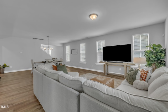 325 Buckhorn Branch Park, Clayton, NC 27520 - living area featuring a chandelier, light wood-style floors, and baseboards