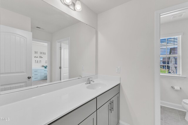520 Oak Holly Ln, Zebulon, NC 27597 - bathroom with toilet, vanity, baseboards, and tile patterned flooring