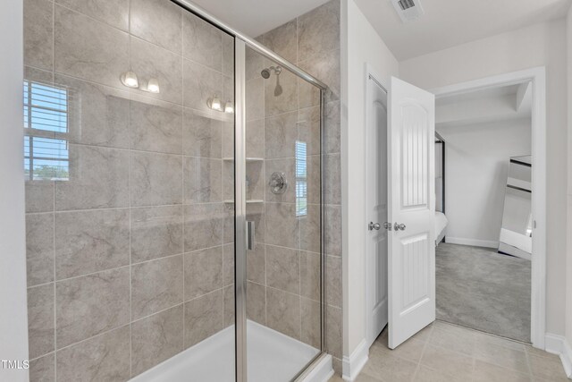 520 Oak Holly Ln, Zebulon, NC 27597 - full bathroom featuring a stall shower, tile patterned flooring, and baseboards