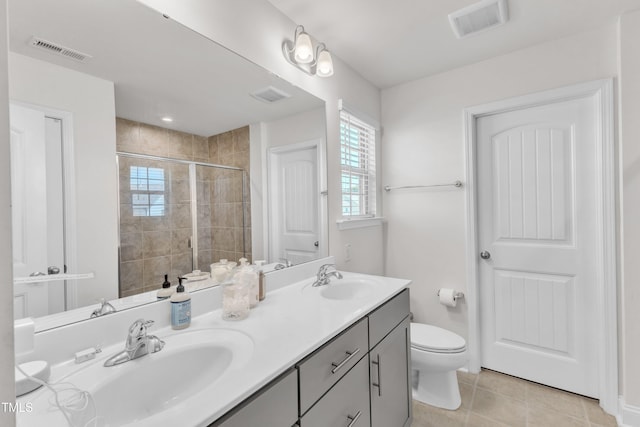 520 Oak Holly Ln, Zebulon, NC 27597 - full bathroom featuring double vanity, tiled shower, toilet, and tile patterned flooring