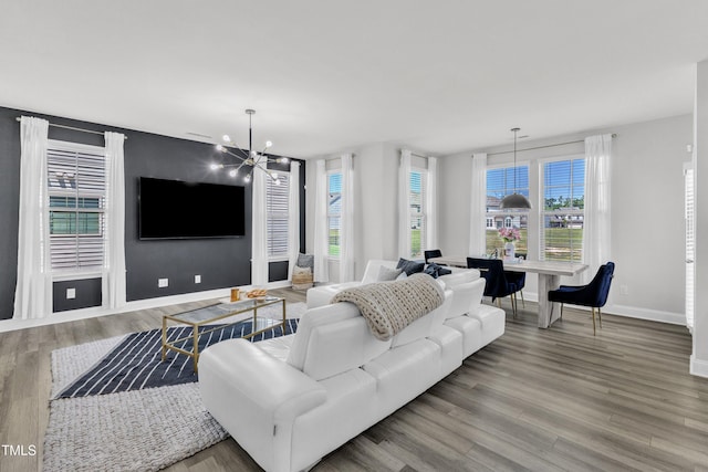 520 Oak Holly Ln, Zebulon, NC 27597 - living room featuring baseboards, a chandelier, and wood finished floors