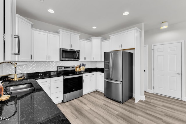 520 Oak Holly Ln, Zebulon, NC 27597 - kitchen featuring appliances with stainless steel finishes, white cabinetry, light wood-style flooring, and recessed lighting