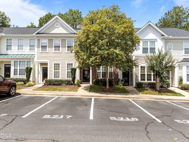 5717 Corbon Crest Ln, Raleigh, NC 27612 - view of property featuring uncovered parking and roof with shingles