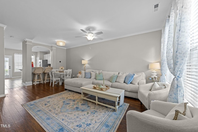 5717 Corbon Crest Ln, Raleigh, NC 27612 - living room featuring ceiling fan, ornamental molding, hardwood / wood-style floors, and arched walkways