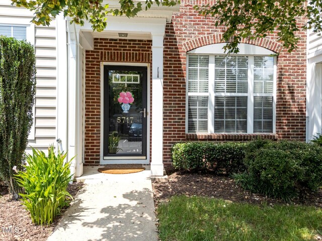 5717 Corbon Crest Ln, Raleigh, NC 27612 - view of exterior entry featuring brick siding