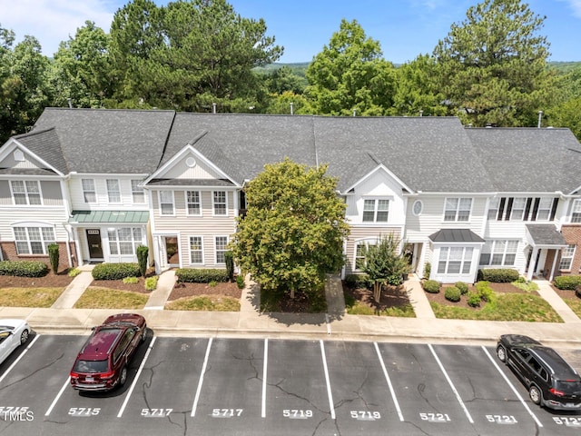 5717 Corbon Crest Ln, Raleigh, NC 27612 - view of front of property featuring a standing seam roof, uncovered parking, a metal roof, and a shingled roof