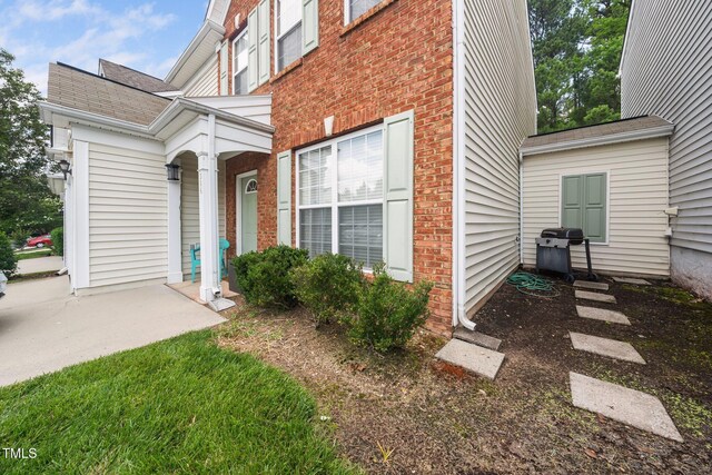 306 Berlin Way, Morrisville, NC 27560 - view of exterior entry with brick siding and roof with shingles