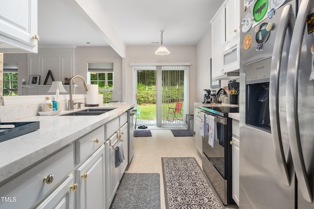 306 Berlin Way, Morrisville, NC 27560 - kitchen with appliances with stainless steel finishes, a sink, white cabinetry, and light tile patterned floors