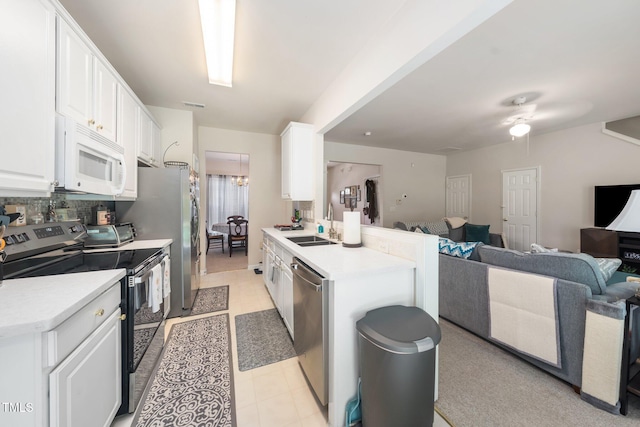 306 Berlin Way, Morrisville, NC 27560 - kitchen featuring stainless steel appliances, open floor plan, a peninsula, and white cabinets