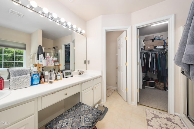 306 Berlin Way, Morrisville, NC 27560 - bathroom featuring double vanity, a walk in closet, a stall shower, and tile patterned floors