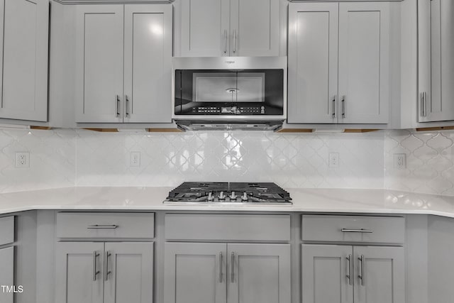 1217 Linkwood Way, Fuquay Varina, NC 27526 - kitchen featuring gray cabinets, appliances with stainless steel finishes, light countertops, and tasteful backsplash