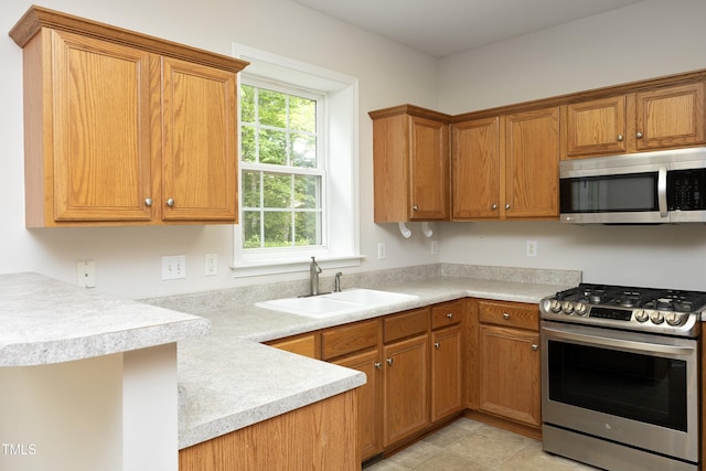 803 High Ct, Hillsborough, NC 27278 - kitchen with appliances with stainless steel finishes, a sink, light countertops, and brown cabinetry