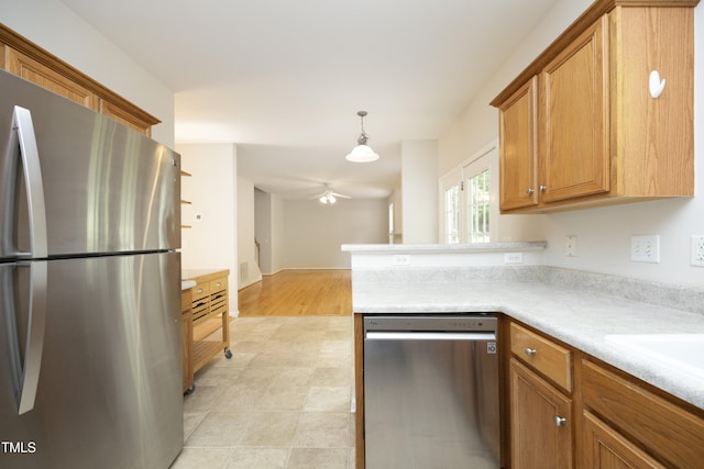 803 High Ct, Hillsborough, NC 27278 - kitchen featuring stainless steel appliances, ceiling fan, light countertops, brown cabinetry, and a peninsula