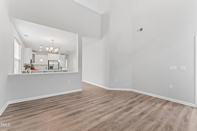 515 Historic Dr, Hillsborough, NC 27278 - unfurnished living room featuring a chandelier and light wood-style floors
