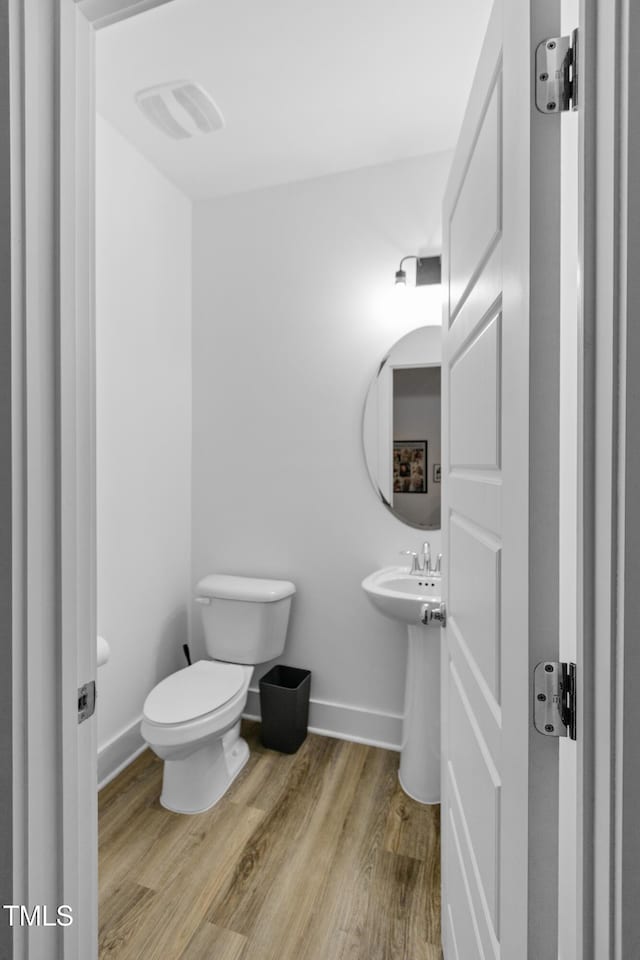 1534 Millrock Trl, Wendell, NC 27591 - bathroom featuring toilet, wood finished floors, and baseboards
