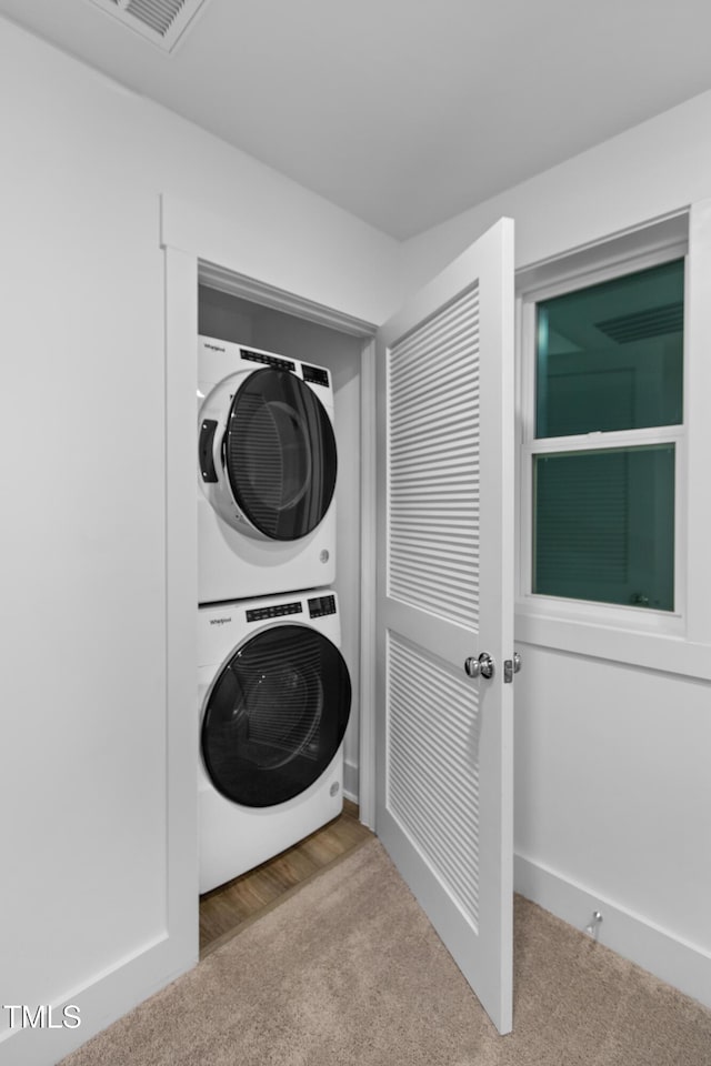 1534 Millrock Trl, Wendell, NC 27591 - laundry area with stacked washing machine and dryer and carpet