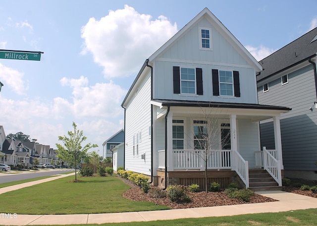 1534 Millrock Trl, Wendell, NC 27591 - view of front of house featuring covered porch, board and batten siding, and a front yard