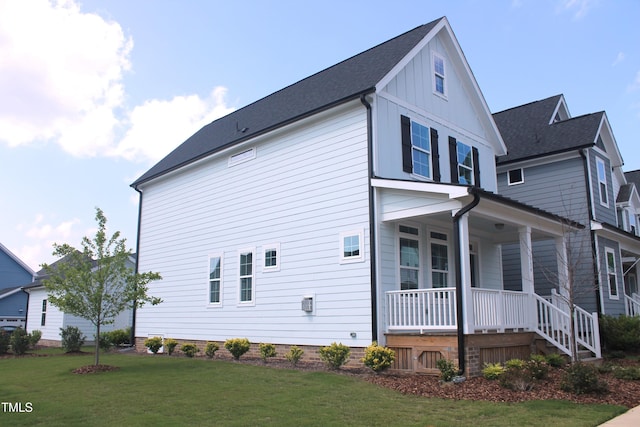 1534 Millrock Trl, Wendell, NC 27591 - view of side of property with covered porch, a lawn, and board and batten siding