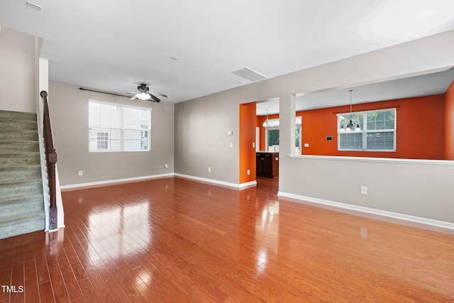 109 Citrine Ct, Durham, NC 27703 - unfurnished living room featuring wood finished floors, baseboards, a ceiling fan, and stairs