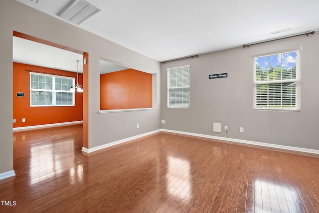 109 Citrine Ct, Durham, NC 27703 - empty room with wood finished floors, baseboards, and a chandelier