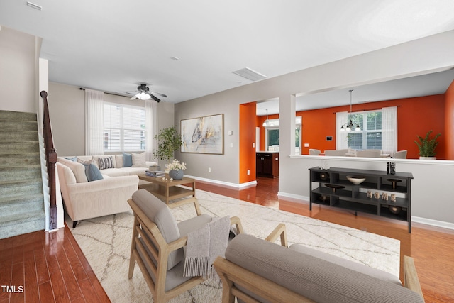 109 Citrine Ct, Durham, NC 27703 - living area featuring wood finished floors, healthy amount of natural light, baseboards, and stairs
