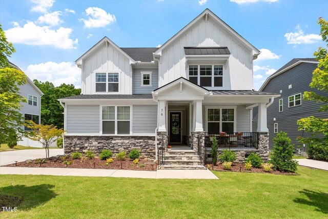 74 Permit Ct, Chapel Hill, NC 27517 - craftsman house with board and batten siding, a front lawn, covered porch, and stone siding
