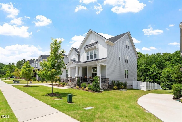 74 Permit Ct, Chapel Hill, NC 27517 - view of side of home with board and batten siding, covered porch, a standing seam roof, and metal roof