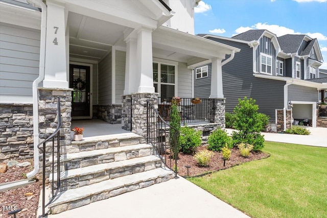 74 Permit Ct, Chapel Hill, NC 27517 - view of exterior entry featuring covered porch, stone siding, and a lawn