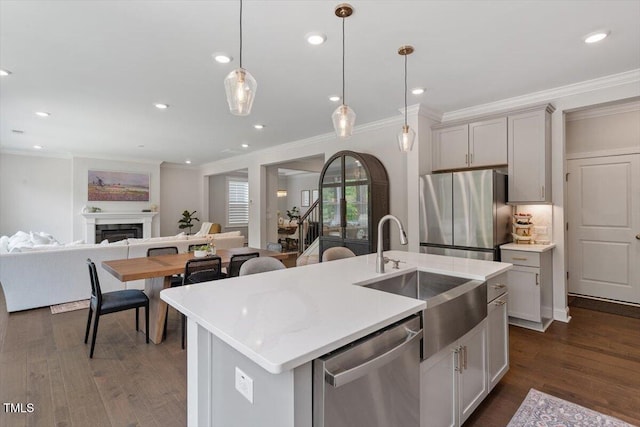 74 Permit Ct, Chapel Hill, NC 27517 - kitchen with stainless steel appliances, crown molding, a sink, open floor plan, and dark wood-type flooring