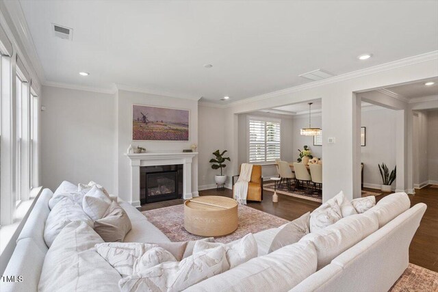 74 Permit Ct, Chapel Hill, NC 27517 - living area featuring wood finished floors, recessed lighting, a glass covered fireplace, ornamental molding, and baseboards